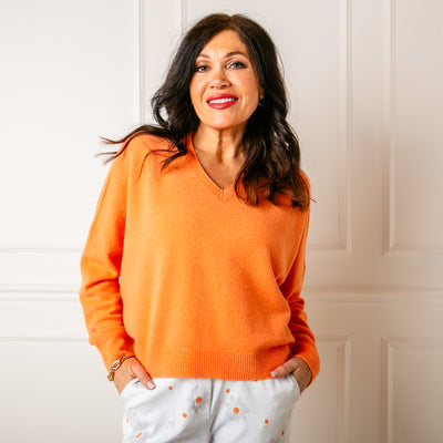 The orange V Neck Short Jumper with long sleeves for a comfy fit